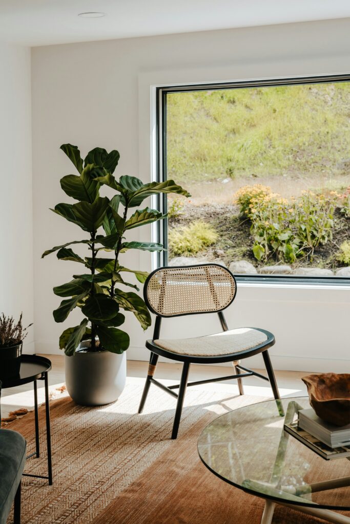 A reading nook with an armchair, floor lamp, and indoor plant.