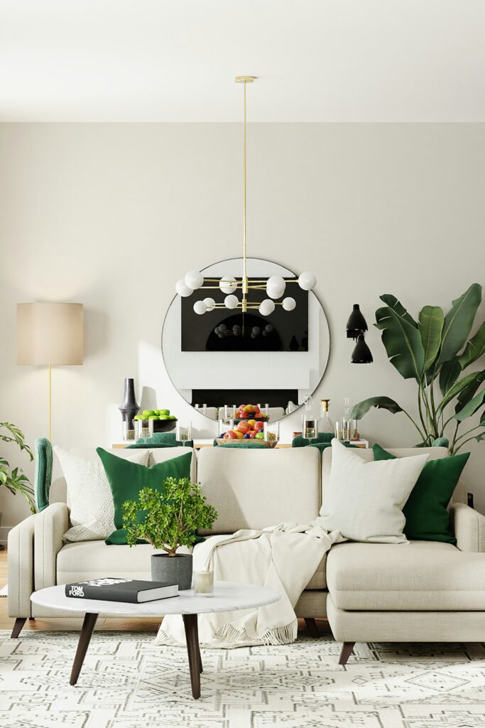  A beige sofa with green cushions, a round coffee table, and an indoor plant. A large round mirror hangs above the sofa.