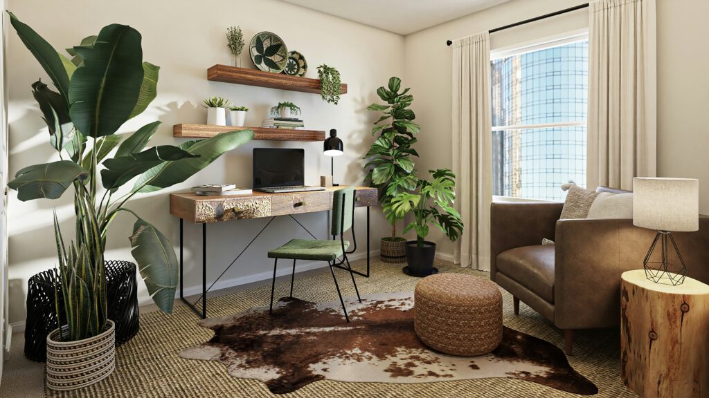 A wooden desk with a computer setup, wall-mounted shelves, and a tall potted plant.